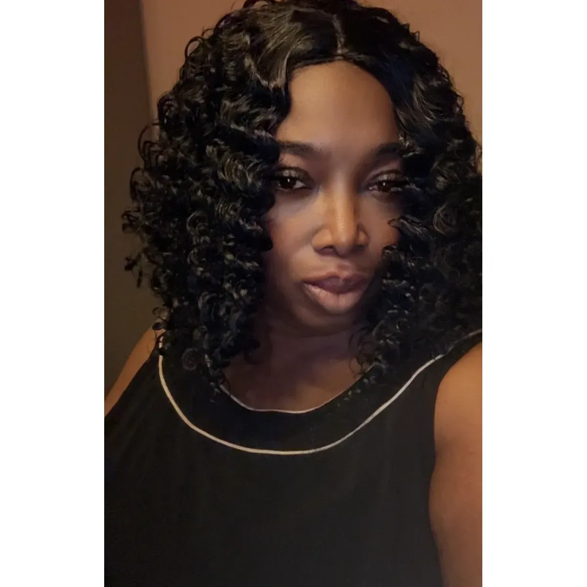 Wet & Go Black Wig with soft black curls, worn by a model